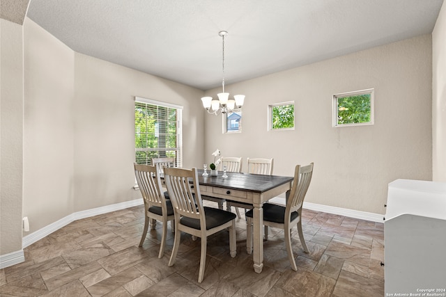 dining area with an inviting chandelier