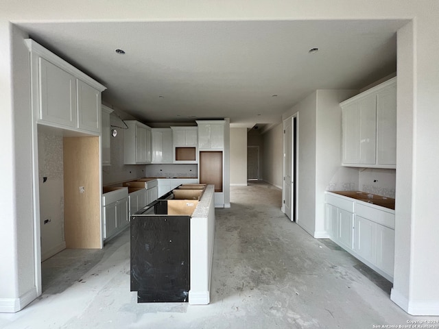 kitchen with white cabinetry and a center island