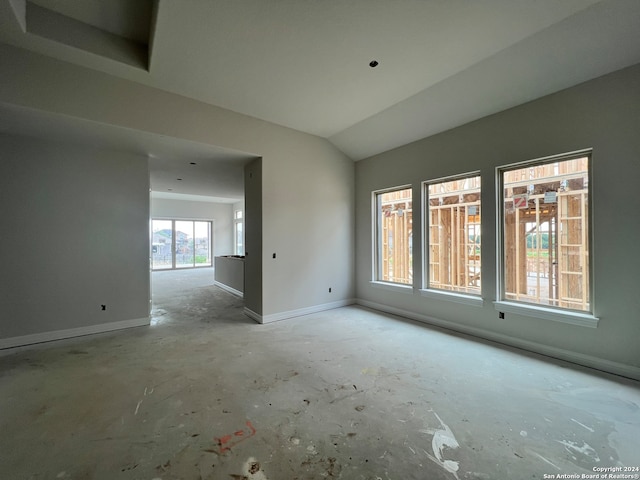 empty room featuring vaulted ceiling