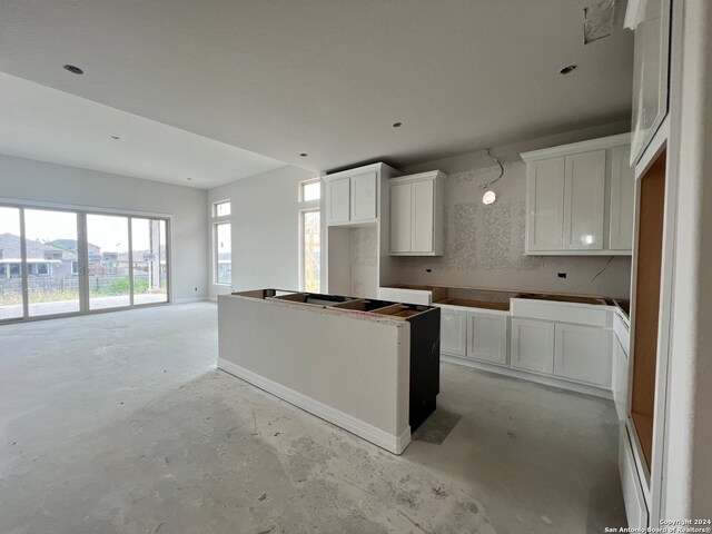 kitchen featuring white cabinets and a center island