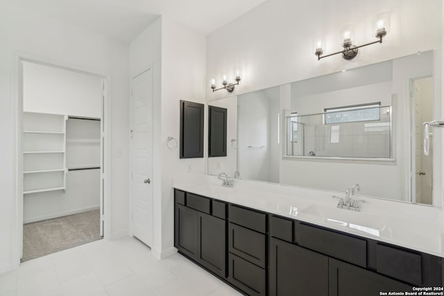 bathroom with vanity, tile patterned floors, and a shower with shower door