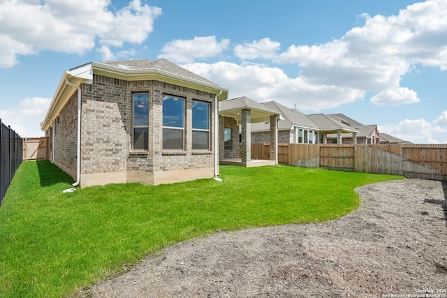 back of property featuring a yard and a patio