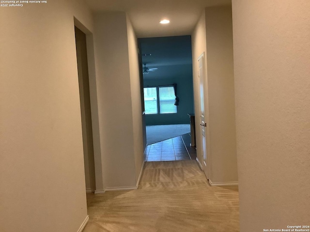 hallway featuring light colored carpet