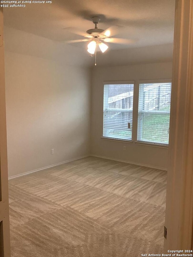 empty room featuring carpet and ceiling fan