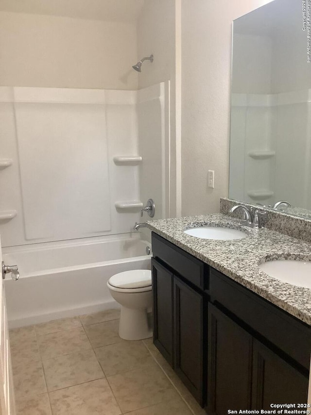 full bathroom featuring tile flooring, double sink vanity, shower / bath combination, and toilet