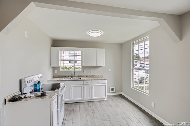 kitchen with white cabinetry, sink, electric range, and light hardwood / wood-style flooring