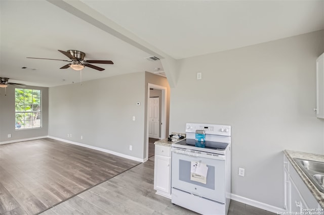 kitchen featuring white range with electric cooktop, light hardwood / wood-style flooring, white cabinets, sink, and ceiling fan