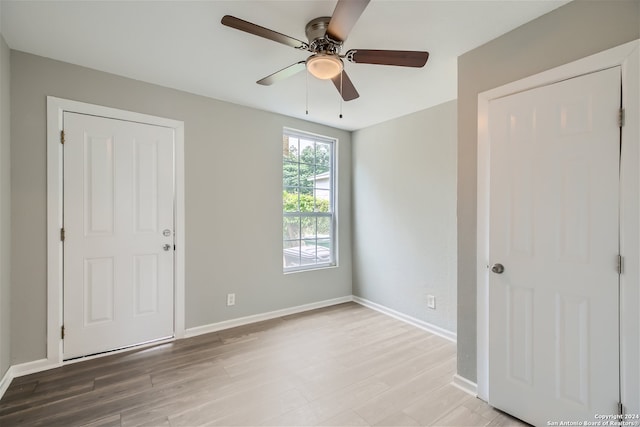 unfurnished room with hardwood / wood-style flooring and ceiling fan