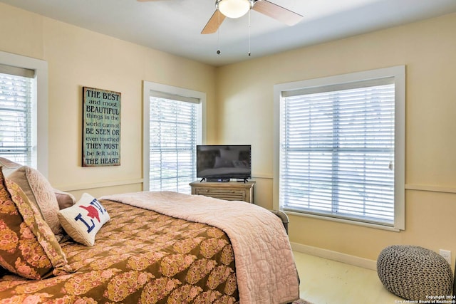 bedroom with multiple windows and ceiling fan