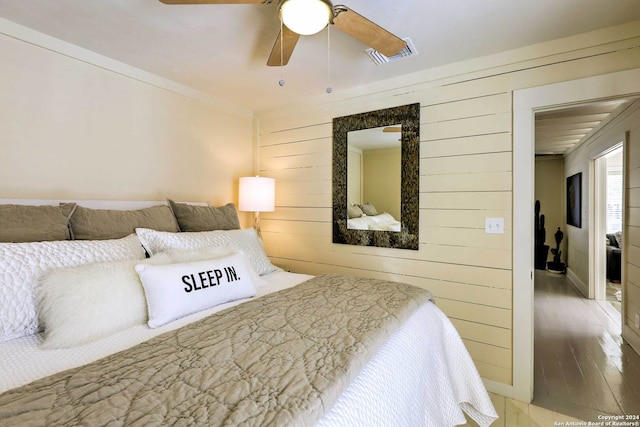 bedroom with ceiling fan and hardwood / wood-style flooring