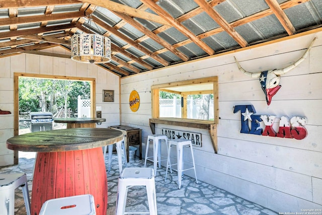 interior space featuring wood walls and vaulted ceiling