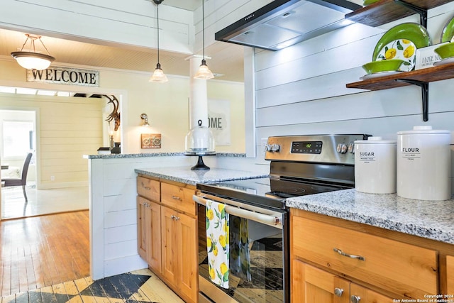 kitchen with light stone counters, custom exhaust hood, stainless steel electric range oven, and light hardwood / wood-style floors