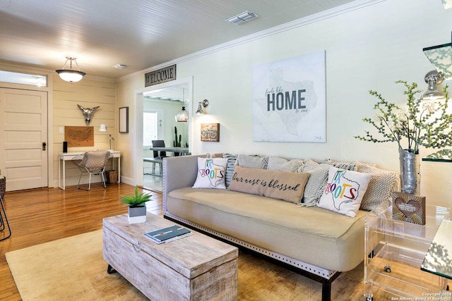 living room featuring crown molding and hardwood / wood-style floors