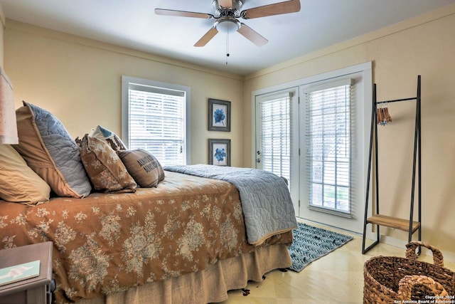 bedroom featuring ceiling fan, access to exterior, and hardwood / wood-style flooring