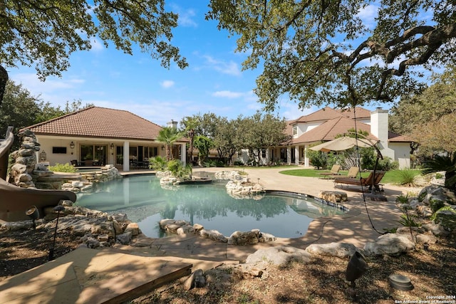 view of swimming pool featuring a patio area