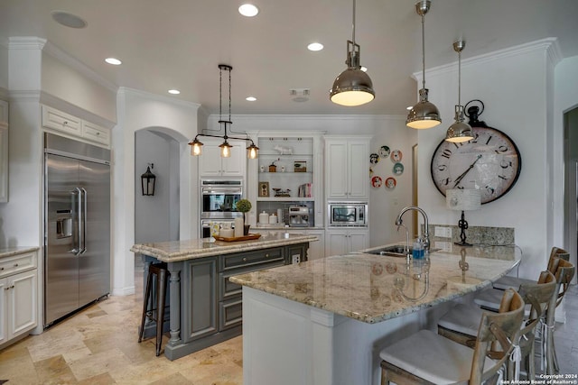 kitchen featuring kitchen peninsula, white cabinets, built in appliances, decorative light fixtures, and sink