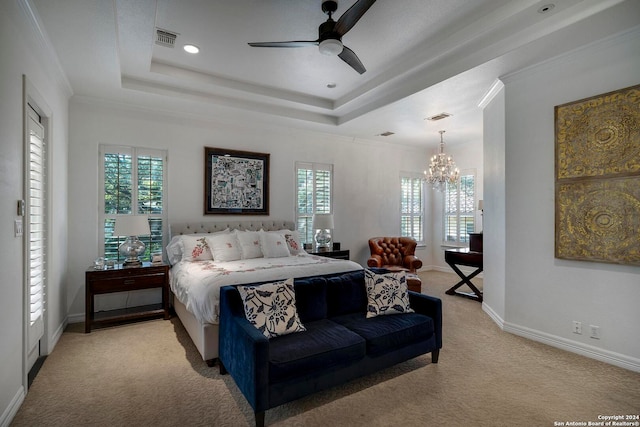 carpeted bedroom with multiple windows, ornamental molding, ceiling fan with notable chandelier, and a raised ceiling