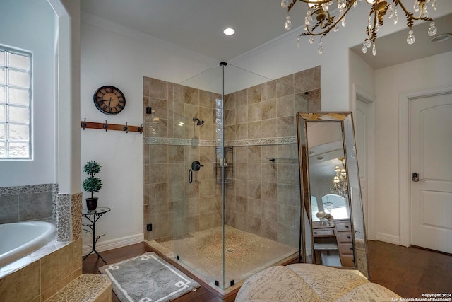 bathroom with hardwood / wood-style floors, crown molding, and shower with separate bathtub