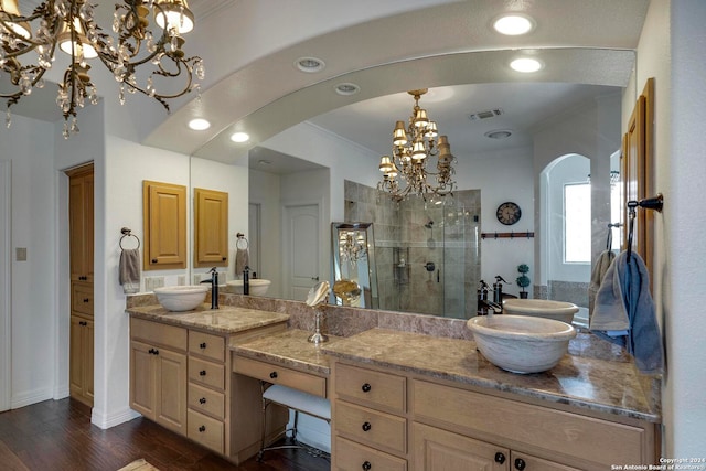 bathroom with wood-type flooring, an enclosed shower, vanity, crown molding, and a chandelier