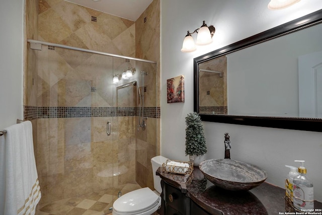 bathroom featuring vanity, toilet, and an enclosed shower