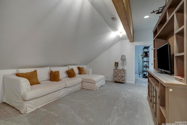 living room with lofted ceiling, light carpet, and a textured ceiling