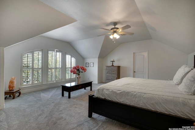 carpeted bedroom featuring ceiling fan and vaulted ceiling