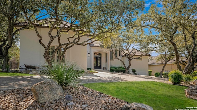 mediterranean / spanish-style home with a front lawn