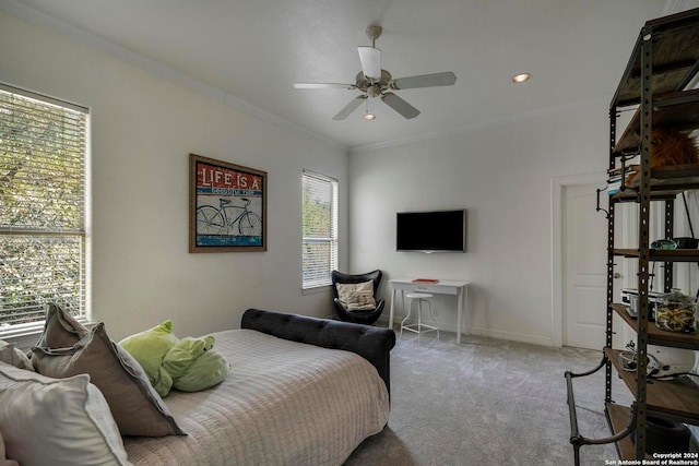 bedroom with crown molding, light colored carpet, and ceiling fan