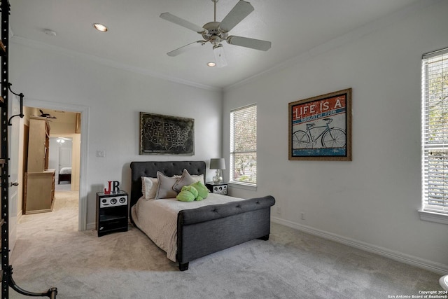 carpeted bedroom featuring multiple windows, crown molding, and ceiling fan