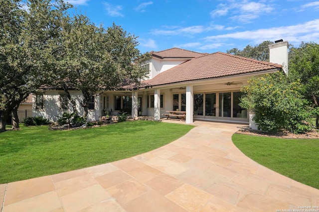 back of house with a patio, a lawn, and ceiling fan