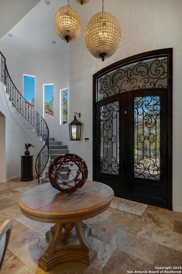 entryway with french doors and a high ceiling