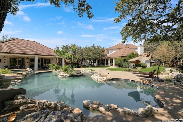 view of swimming pool featuring an in ground hot tub and a patio