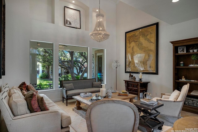 living room featuring a towering ceiling and an inviting chandelier