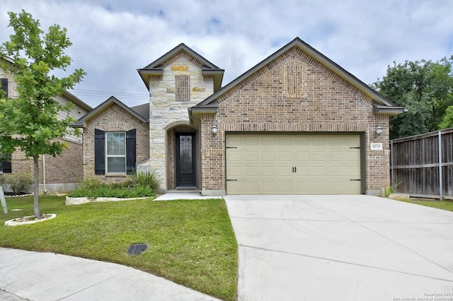 view of front of property featuring a garage and a front yard