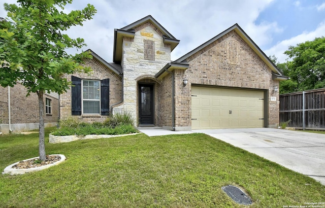 view of front facade featuring a front yard and a garage