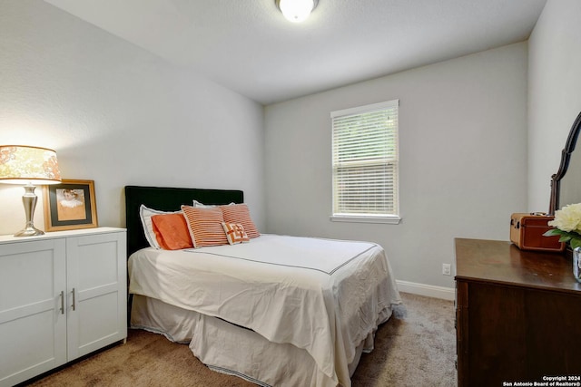 bedroom featuring light colored carpet