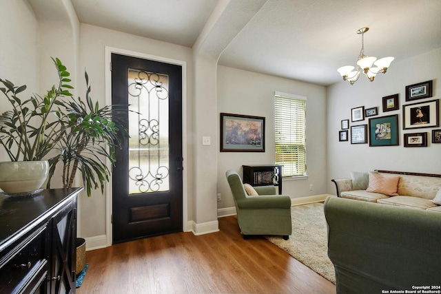 entryway featuring hardwood / wood-style flooring and a notable chandelier