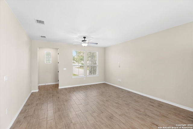 spare room featuring ceiling fan and light hardwood / wood-style flooring