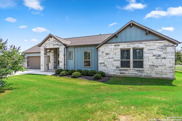 view of front of home with a garage and a front yard