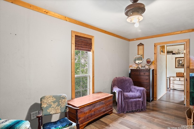 sitting room featuring ornamental molding and hardwood / wood-style flooring