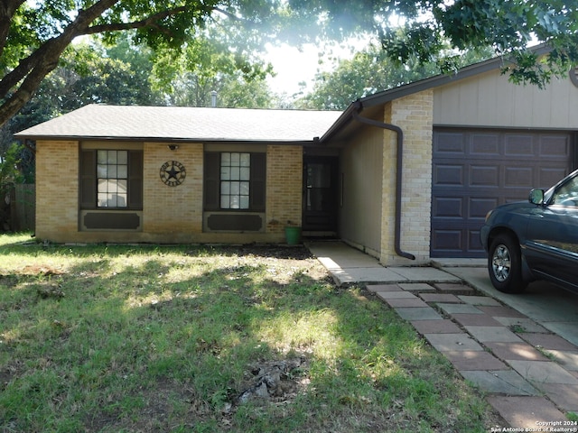 single story home with a garage and a front lawn