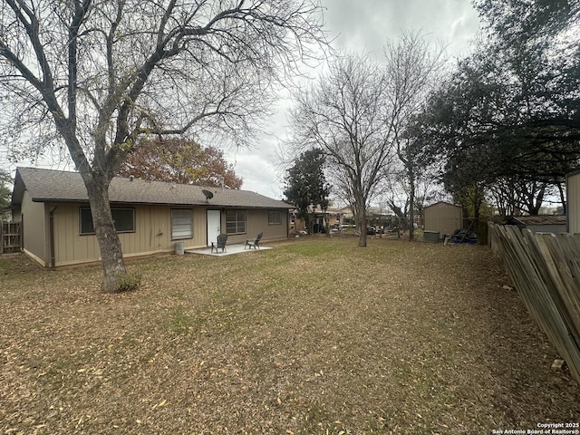 view of yard featuring a patio and a storage unit