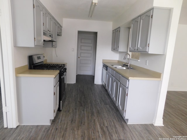 kitchen with gray cabinetry, sink, stainless steel dishwasher, dark hardwood / wood-style floors, and white range with gas stovetop