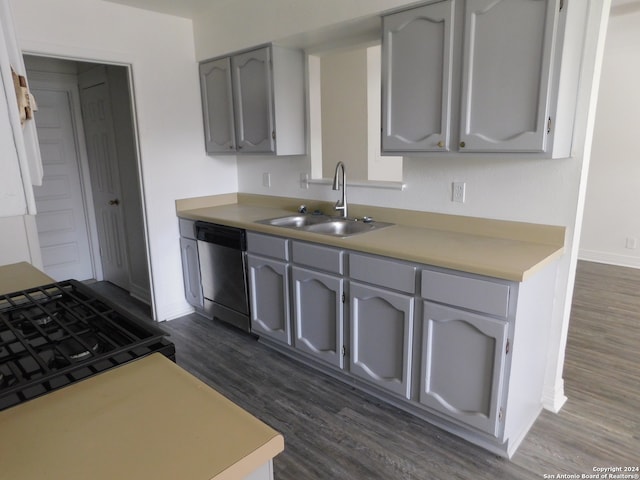 kitchen featuring black stove, dark hardwood / wood-style flooring, gray cabinetry, sink, and dishwasher