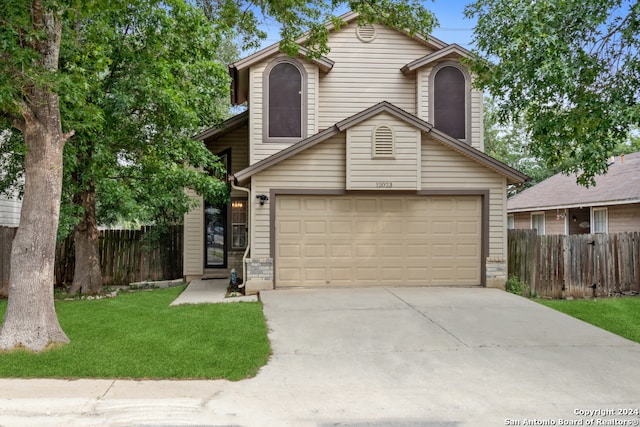 view of front property with a garage and a front lawn