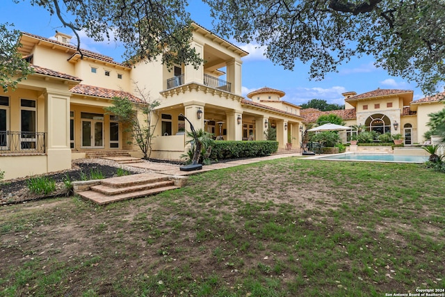 back of property with a balcony