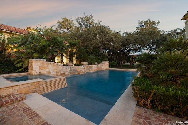 136 S Tower Hl, Country Village, TX 78232 - pool at dusk featuring an in-ground hot tub and an outdoor pool