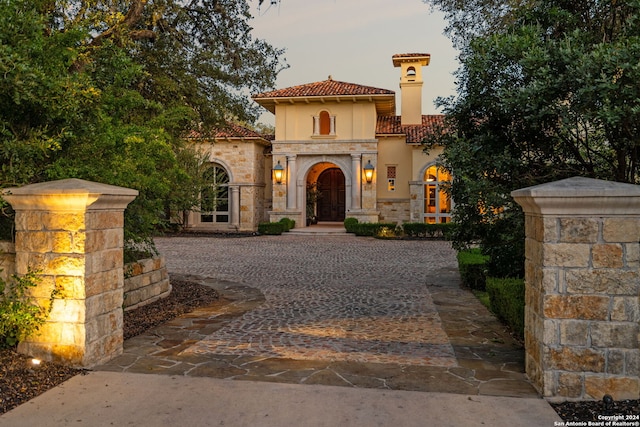 136 S Tower Hl, Country Village, TX 78232 - mediterranean / spanish-style home featuring a tile roof, stucco siding, stone siding, and a chimney