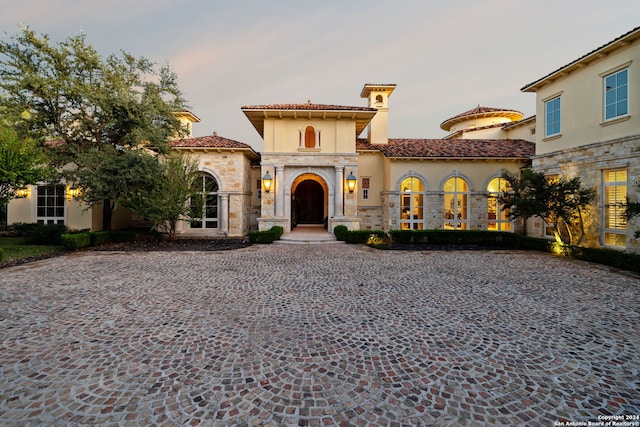 136 S Tower Hl, Country Village, TX 78232 - mediterranean / spanish house featuring a tile roof, stone siding, stucco siding, and driveway
