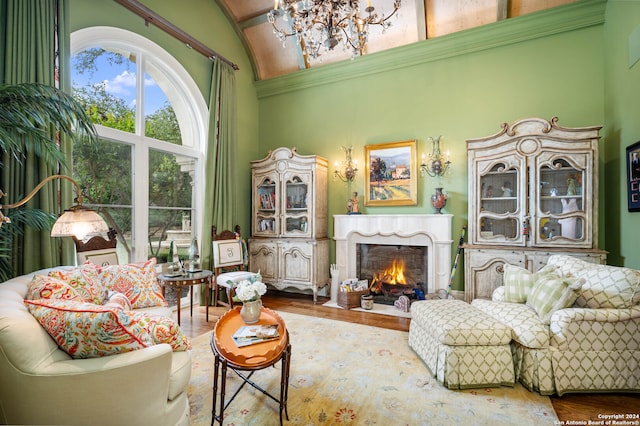 sitting room featuring hardwood / wood-style flooring and high vaulted ceiling